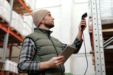 A warehouse worker inspects packages on a shelf – Slotted